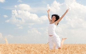happy-woman-jumping-in-golden-wheat